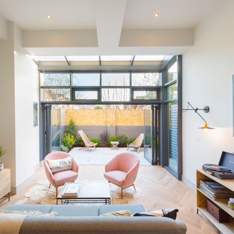 living room of Fulham conversion showing vintage refurbished chairs from Galapagos Designs with Designers Guild Allia fabric