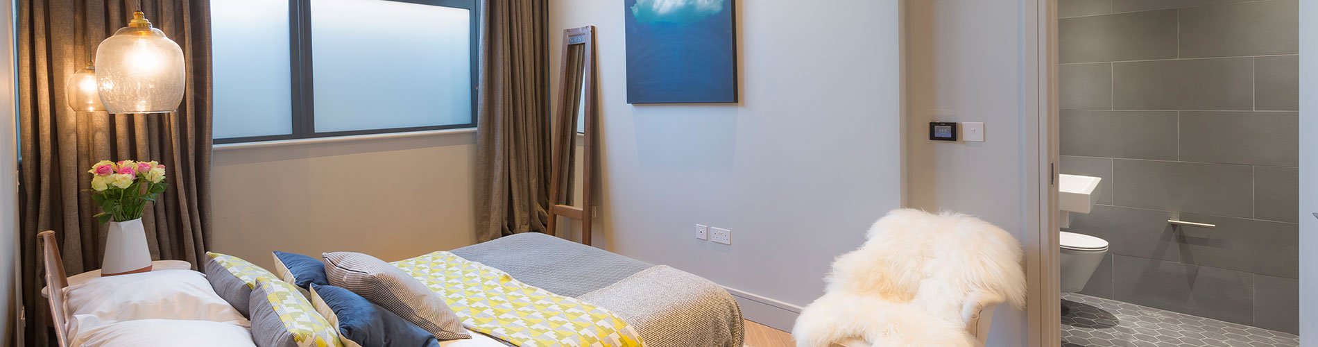 bedroom design by Element Studios with Eleanor Pritchard yellow throw and cushions and Ciara McGarrity sheers and curtains