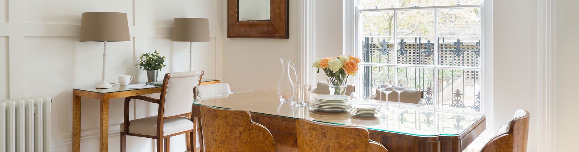 Listed Building conversion Lambeth dining room with contemporary glass topped walnut table and chairs and white panelling