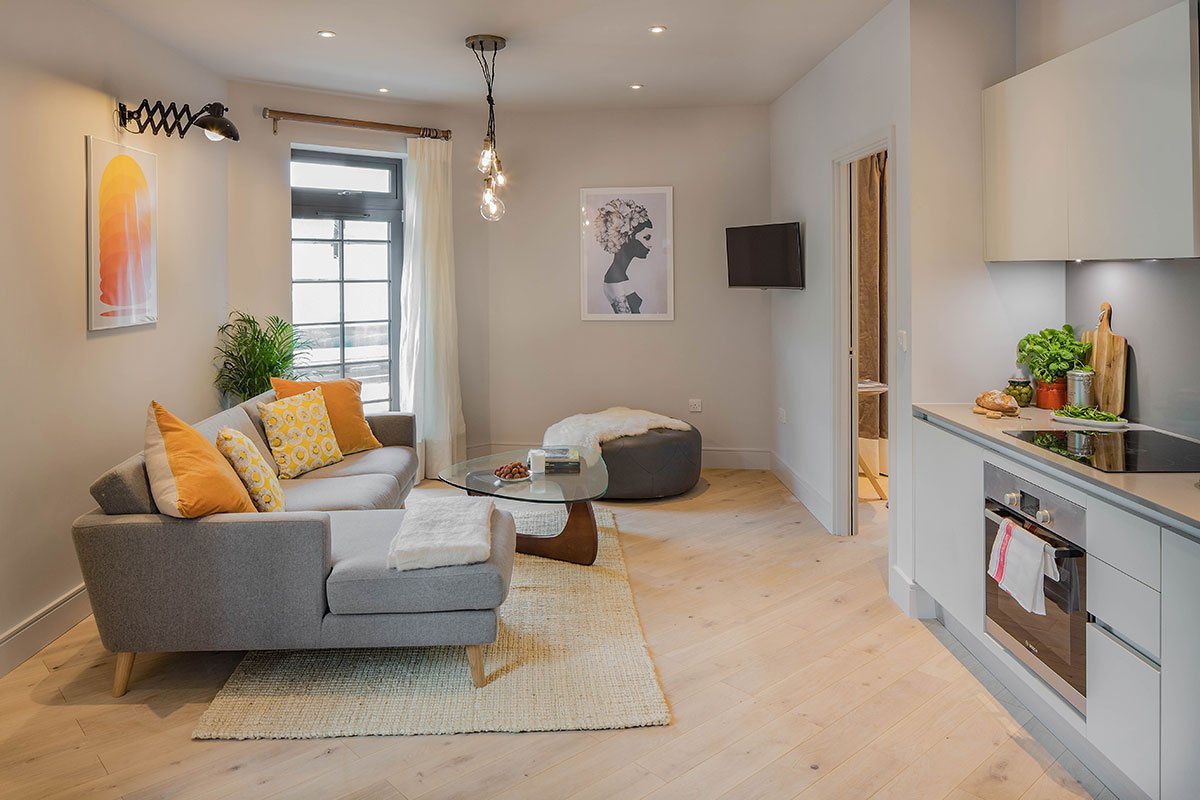 living room kitchen with vintage and retro affordable fixtures and fittings in pale greys and yellow by Element Studios