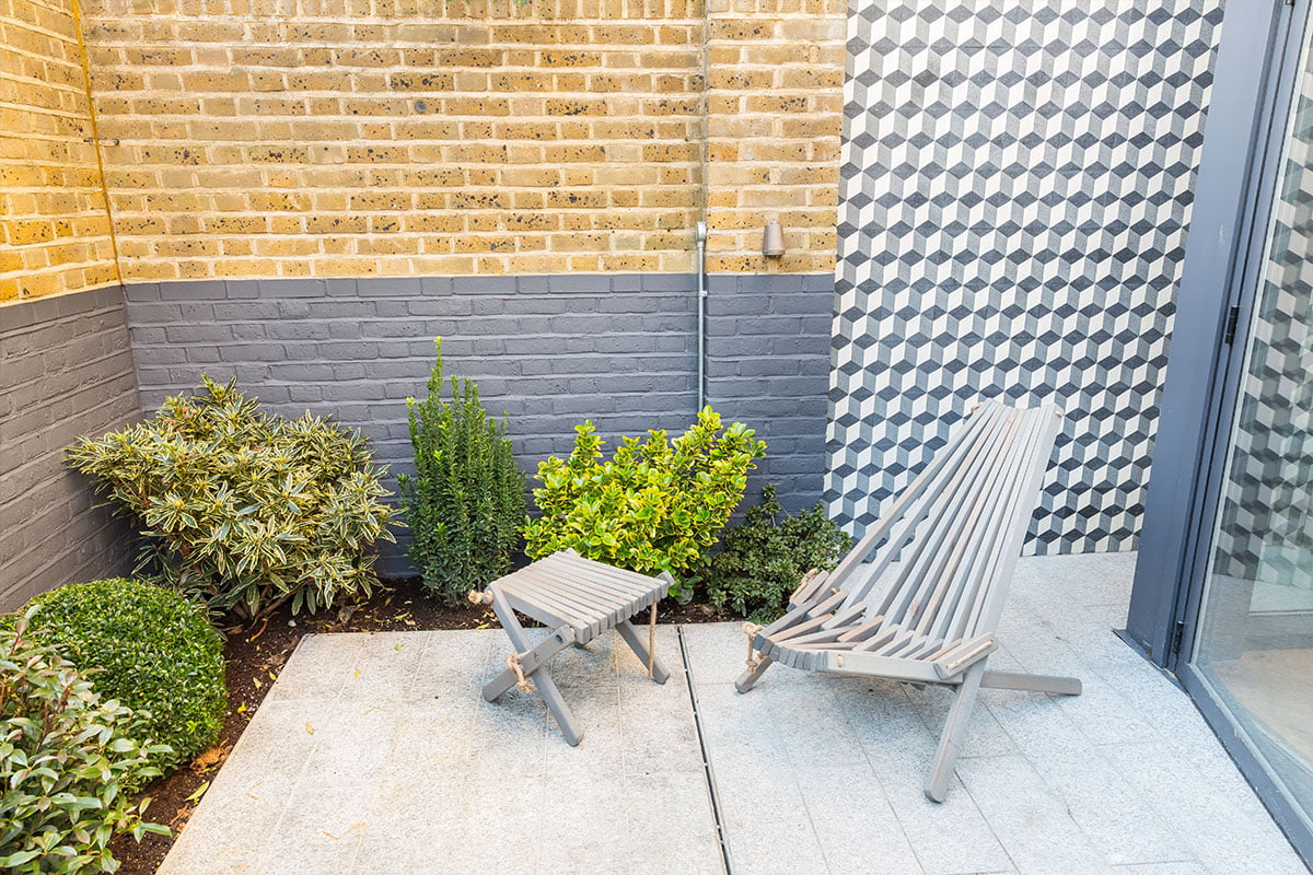 Verve Properties Hunts Paper Factory outdoor courtyard with Mosaic Del Sur cement Granito tiles and Harmen chair and stool