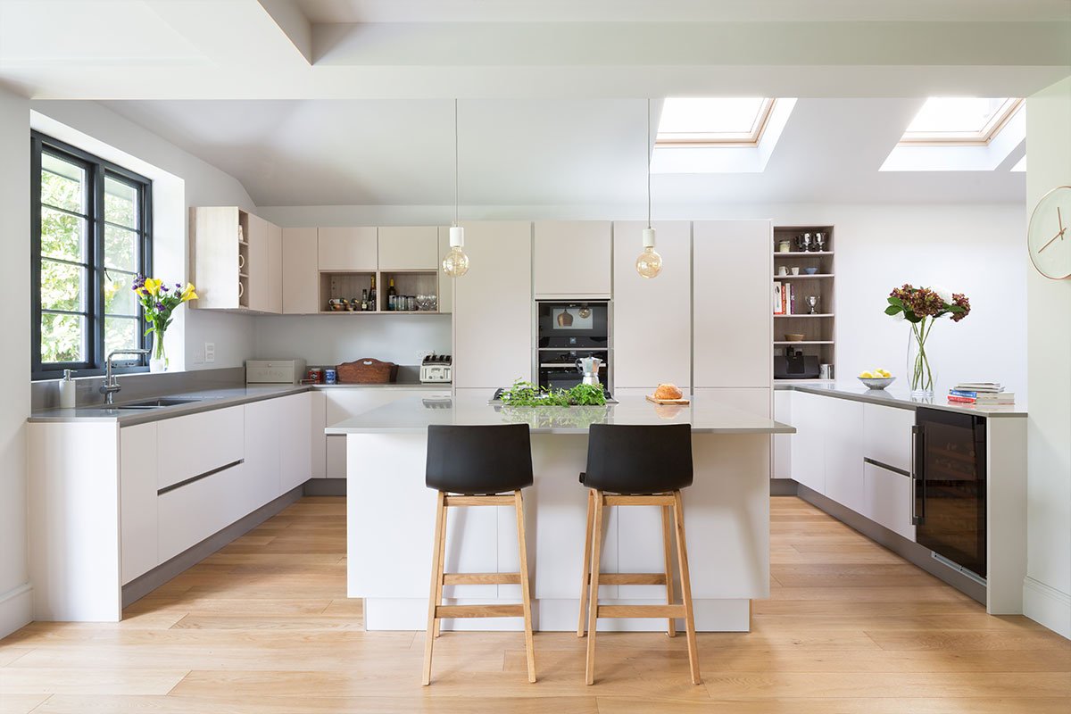 Kochwerk German open-plan kitchen with Bristol pendants from Heals over stone worktop home refurbishment from Element Studios