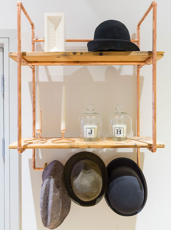 Interior detail of bespoke copper coat stand from Steel Roots Design with London brick vase by Stolen Form by Element Studios