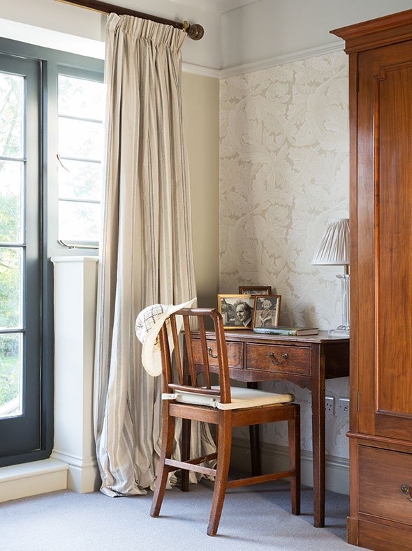 master bedroom showing antique oak desk and chair with Morris & Co Acanthus wallpaper & Drop Cloth matt emulsion on walls