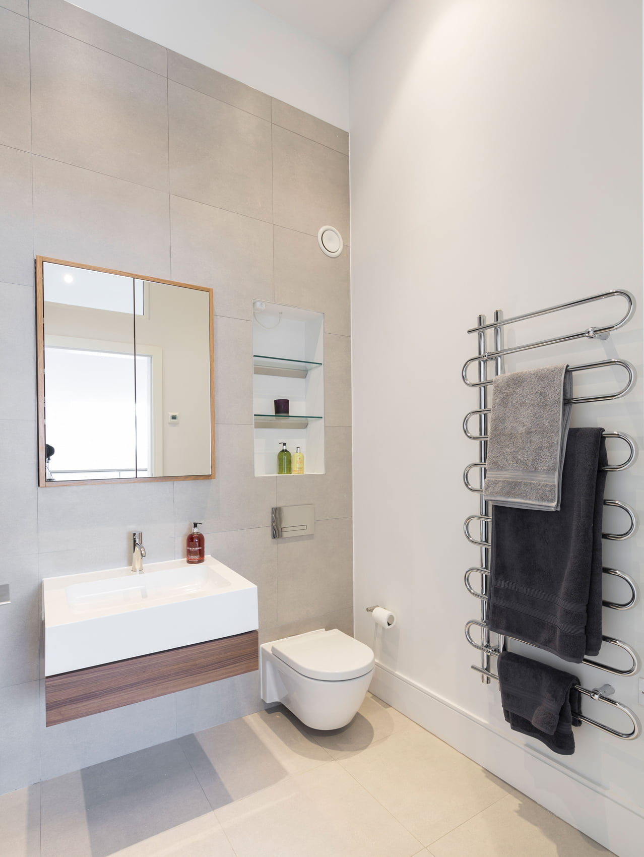 luxury bathroom with recessed shelving and white porcelain bespoke flush mirrored cabinet designed by Element Studios