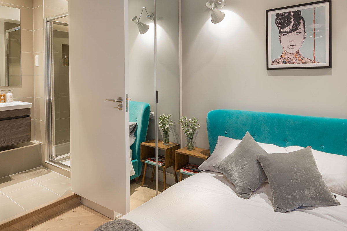 Verve Properties Brentford flat designed by Element Studios with retro bedside tables and Belize velvet blue bed from Loaf