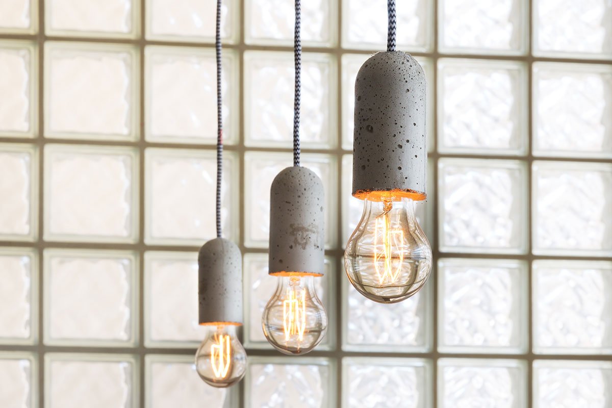refurbished interior of ammunitions factory East London with industrial glass blocks and Nud concrete pendant lights from SCP