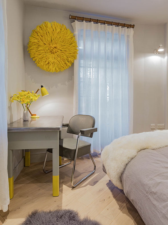 1950s French writing desk with grey tub chair and Juju yellow hat on wall behind bedroom interior design by Element Studios