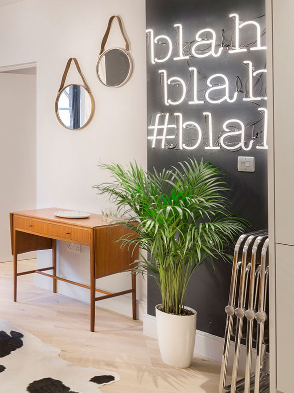 Brentford flat living room with vintage drop leaf table from Funky Junky neon sign and Pamono vintage Castelli folding chairs