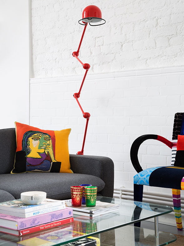 Living room interior with red Jielde floor lamp from Holloways of Ludlow Squint chair and Picasso cushion The Conran Shop