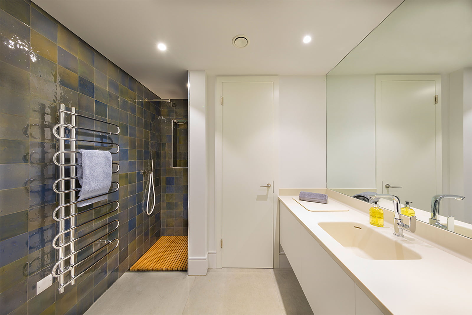 utility by Element with glazed wall tiles and Corian sink unit including shower with flush hardwood timber slatted tray