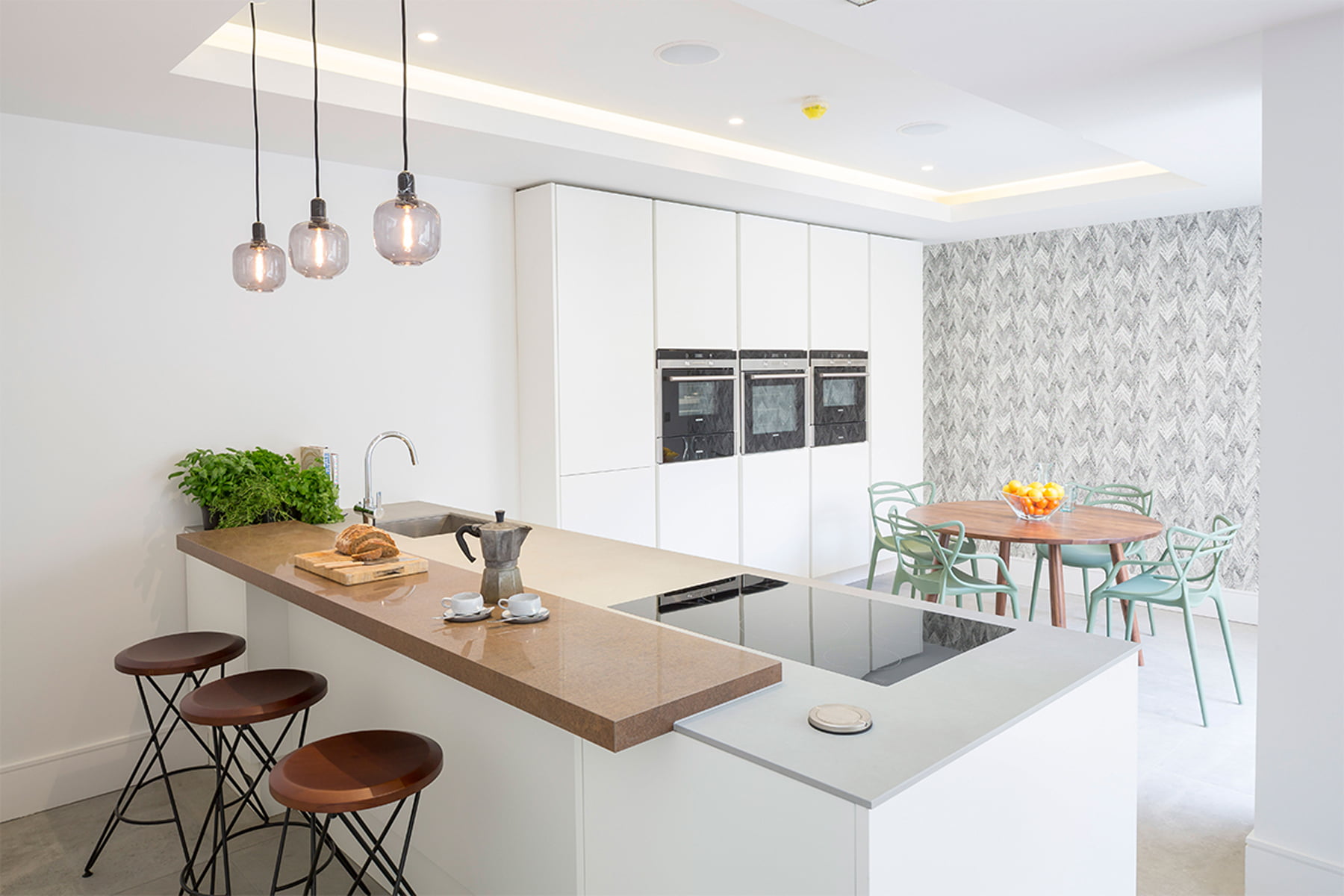 Kochwerk German kitchen with Kartell Masters sage chairs Amp pendant Normann Copenhagen Itsuki wallcovering by Lovat