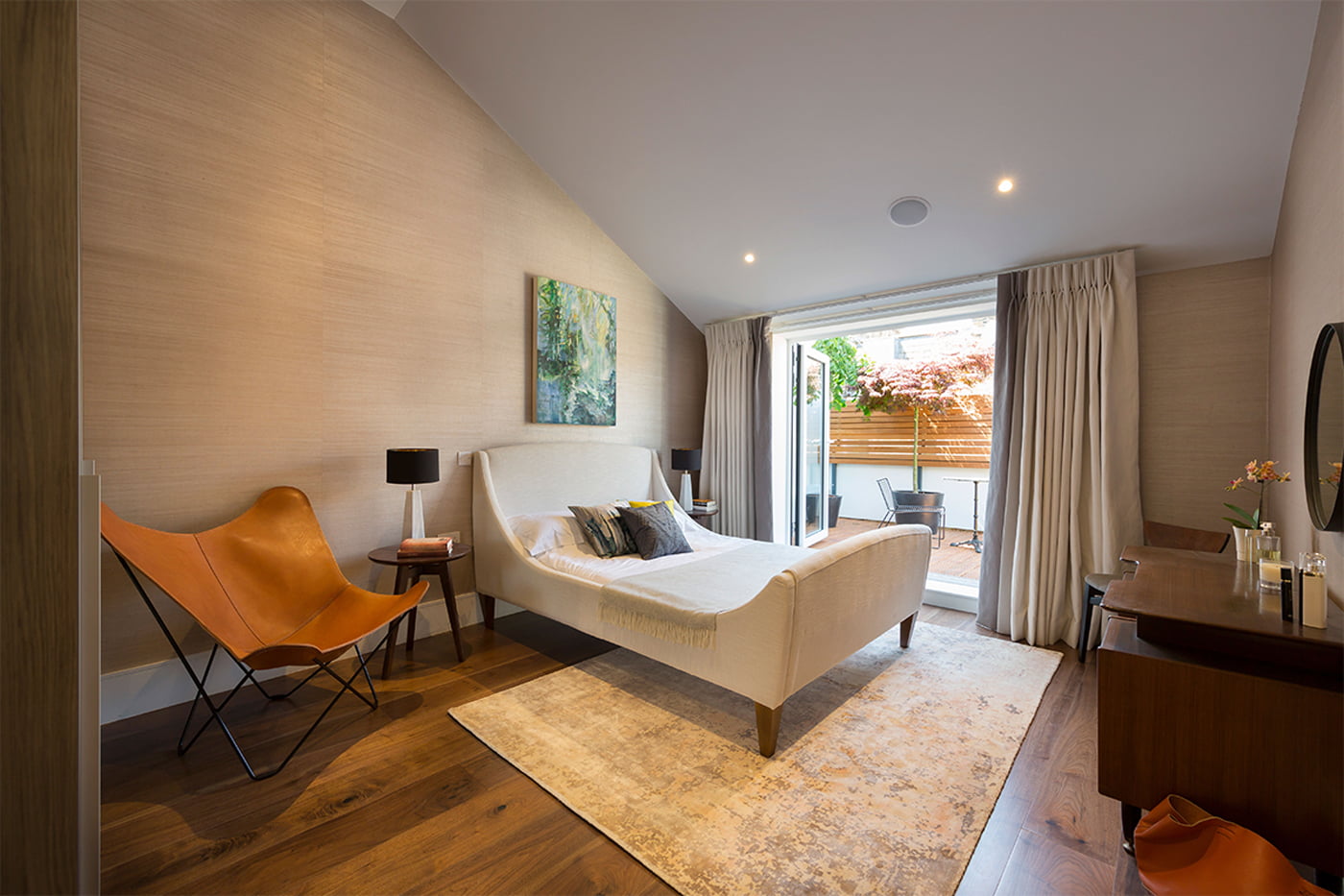 Element Studios Fulham bedroom with vintage leather Mariposa Butterfly chair Phillip Jeffries off Broadway beige wallcovering